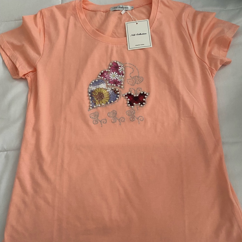 New woman t-shirt with tags. Size is L/X but is mostly M.